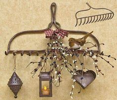 a bird is perched on a coat rack with ornaments hanging from it's hooks