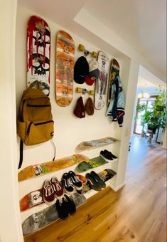 there are many skateboards on the wall and in the hallway, as well as shoes