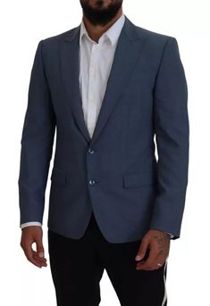 This Dolce & Gabbana blazer, made in Italy, features a blue inner lining and is crafted with a mix of high-quality materials, including 92% wool, 7% elastane, and 1% polyester. The single-breasted style, two-button closure, and logo details make for a sleek and sophisticated look. The lining is composed of 36% cupro, 33% rayon, and 31% acetate for added comfort and durability. Model: Blazer jacket sport Style: Single breasted Color: Blue Blue inner lining Two button closure Logo details Made in Blue Slim Fit Blazer For Business, Blue Slim Fit Blazer For Office, Luxury Blue Blazer For The Office, Luxury Blue Blazer For Office, Luxury Blue Office Blazer, Luxury Blue Outerwear With Single Button, Blue Slim Fit Blazer With Long Sleeves, Blue Slim Fit Long Sleeve Blazer, Luxury Single-button Blue Outerwear