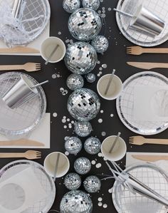 disco balls and silver plates on a black table