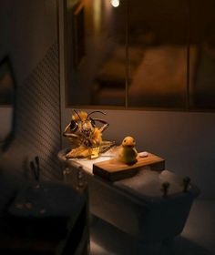 a bathroom with a sink, mirror and light in the dark night time lighting up the room