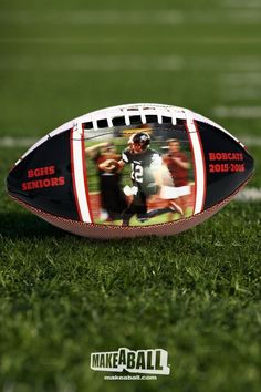 a football laying on top of a field with the image of a football in it's center