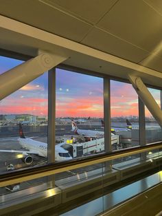 an airport terminal with planes parked at the gates and windows looking out onto the tarmac