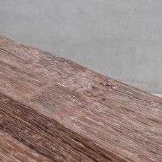 an old wooden table with white paint on it's surface and wood grains