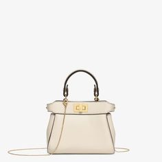 Iconic Nano Peekaboo bag with every detail recreated. Featuring a leather-lined interior, two compartments separated by a stiff partition, a removable handle with two press studs and the classic twist lock. It can be carried by hand or worn cross-body thanks to the fine chain shoulder strap. Made of camellia-coloured nappa leather. Gold-finish metalware. It can hold a Fendi mini fragrance, a card, headphones, keys and a lipstick. Made in Italy. One Size Pink Peekaboo, Pink Fendi, Peekaboo Bag, Fendi Pink, Fendi Shoulder Bag, Fendi Peekaboo, Lock It, Shoulder Strap Bag, Travel Bags For Women