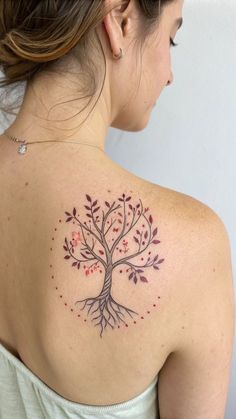 a woman with a tree tattoo on her back