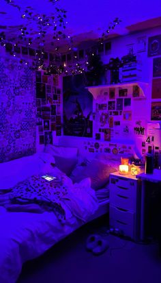 a bedroom with purple lighting and pictures on the wall