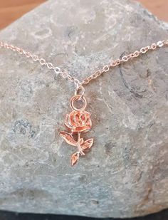 Really pretty delicate rose gold coloured necklace with flower pendant. Made from rose gold plated flat cable chain, 43 cm and can be extended with 5cm of extendable chain.  The pendant is a pretty rose pendant which is made from a rose gold coloured alloy, size 10.5mm wide, 21mm long and 2.5mm thick.  All lead and nickle safe. Keep made moisture free and wipe with a soft cloth after each use to maintain shine.  Comes packaged in a gift box. Elegant Rose Gold Flower Charm Necklaces, Elegant Rose Gold Flower Charm Necklace, Dainty Rose Gold Necklace With Rose Design, Rose Gold Charm Necklace With Flower Pendant, Delicate Rose Gold Charm Necklace With Clavicle Chain, Delicate Rose Design Rose Gold Jewelry, Delicate Rose Gold Necklaces With Roses, Delicate Rose Gold Jewelry With Rose Design, Rose Gold Necklace With Flower Pendant