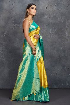 Dazzle at weddings like Bollywood diva Rekha in this royal yellow Kanjivaram saree! The saree is enhanced with blue zari border and zari pallu. It comes with a matching blouse piece. Shop silk sarees in USA from Pure Elegance. Disclaimer: The shown stitched blouse on the model is for display purpose only. The saree comes with a matching blouse piece and finished with fall and piko. Yellow Handloom Pre-draped Saree For Wedding, Festive Yellow Paithani Silk Pre-draped Saree, Gold Paithani Silk Pre-draped Saree, Yellow Katan Silk Pre-draped Saree, Yellow Paithani Silk Anarkali Pre-draped Saree, Yellow Tissue Silk Saree With Traditional Drape, Yellow Tissue Silk Saree With Pallu Detail, Yellow Tissue Silk Saree With Pallu, Yellow Tissue Silk Saree With Zari Weaving