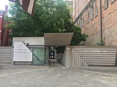 an entrance to a building that is made out of concrete and has stairs leading up to it