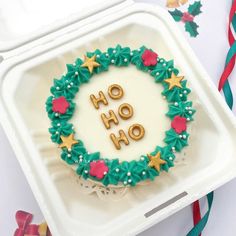 a decorated cookie in the shape of a wreath with words ho hoo on it