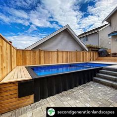 an above ground swimming pool with steps leading up to it and a wooden fence around it