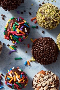 several different types of donuts with sprinkles and chocolate frosting on them