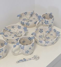 a table topped with blue and white dishes next to utensils on top of a counter