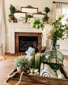 a living room filled with lots of furniture and flowers on top of a wooden table