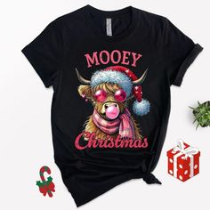 Get into the festive spirit with a touch of humor! Our 'Mooey Christmas' t-shirt features a hilarious cow with pink glasses and chewing bubble gum, guaranteed to turn heads. This fun shirt is the perfect gift for your loved ones or a playful addition to your holiday party wardrobe. Embrace the blend of style and laughter as you kick off the new year in delightful fashion! Hey there, style icon! These shirts are special pieces that fill me with joy and excitement while designing them just for you Winter Holiday Funny T-shirt, Funny Winter Holiday T-shirt, Christmas Novelty Crew Neck T-shirt, Mooey Christmas, Farm Christmas, Pink Glasses, Cow Farm, Fun Shirt, Crew Neck Shirt