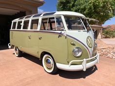 an old vw bus parked in front of a house