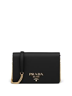 Black leather logo-lettering Saffiano leather shoulder bag from PRADA featuring Saffiano leather, gold-tone logo lettering, internal logo patch, gold-tone hardware, foldover top with magnetic fastening, leather and chain-link shoulder strap and main compartment. | Prada logo-lettering Saffiano leather shoulder bag Prada Bag Shoulder, Handbag Branding, Prada Chain Bag, Black Prada Bag, Prada Bag Black, Prada Shoulder Bag, Prada Saffiano, Luxury Purses, Fancy Bags