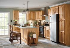 a kitchen filled with lots of wooden cabinets and counter top space next to a window