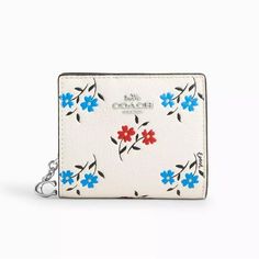 The Coach Women's Small Snap Wallet with Floral Print combines style and function in a compact design. Crafted from refined pebble leather, this wallet features a charming floral print and silver-tone hardware. It includes an outside zip coin pocket, 3 credit card slots, an ID window, and a full-length bill compartment. The snap closure keeps everything secure, and its small size makes it perfect for carrying in smaller bags or on the go. Color: White.  Gender: female.  Age Group: adult. Snap Bag, Banana Bag, Snap Wallet, Signature Canvas, Hanging Bag, Apple Watch Strap, Canvas Leather, Shop Wallpaper, Small Bag