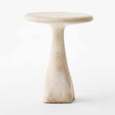 a white table with a small round top on it's side, against a white background