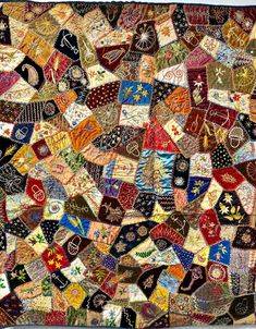 an old quilt with many different colors and designs