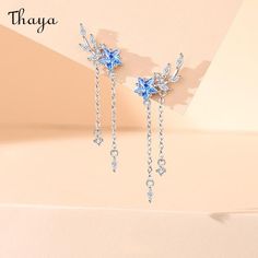 Our Starry Fringe Earrings are inspired by the twinkling night sky and the fluidity of movement. Each earring is delicately crafted with shimmering metal fringe that gracefully sways and catches the light like stars dancing in the sky. Make a statement with these celestial-inspired earrings that add a touch of ethereal beauty to any outfit.   - Brand: Thaya  - Material: S925 Silver Synthetic Cubic Zirconia   - Weight: 2.18g (total weight)   - Size: Height 37.6mm, width 14.85mm  - Gender: Women Dancing In The Sky, Kawaii Design, Special Jewelry, Ethereal Beauty, Fringe Earrings, Twinkle Twinkle, Night Sky, Night Skies, Couple Gifts