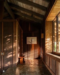 the sun is shining through the windows in an empty room with stone flooring and walls