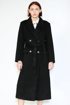 Indulge in timeless elegance with our Double-Sided Wool Black Wrap Coat. This heavyweight classic exudes sophistication and comes complete with a belt for versatile styling. The double-breasted design adds an extra layer of refinement, while the two pockets provide both style and convenience. What sets this coat apart is its full lining, ensuring comfort and warmth in every wear. Wrap yourself in luxurious fashion that effortlessly combines style and practicality. Elevate your winter wardrobe with this standout piece that promises both cozy comfort and chic allure. Composition: 100% Wool Heavyweight fabric Designed for a relaxed fit, fits true to size Made in New York SNOWXUEGAO.COM Black Wrap Coat, Winter Event, Wrap Coat, Asian American, American Fashion Designers, Office Wear, Comforters Cozy, Winter Wardrobe, American Style