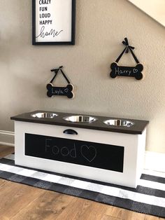 a dog food station with two bowls on top and some signs above it that say happy e