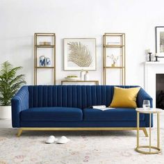 a living room filled with furniture and a fire place in front of a white wall