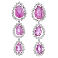 Indulge in the exquisite elegance of these graduated pink tourmaline drop earrings, expertly crafted in 18ct white gold. Each earring showcases a trio of free-hanging, pear-shaped pink tourmalines, gracefully graduated in size. These vibrant gemstones are beautifully framed with milgrain-set diamonds, adding a touch of vintage charm and intricate detail. The harmonious blend of the radiant pink tourmalines and the sparkling diamonds creates a captivating contrast, making these earrings a timeless piece of jewellery that epitomises sophistication and glamour. Perfect for special occasions, these earrings are designed to dazzle and enchant. - Size (LxW): 39 x 11mm - Weight per earring: 3.4g Fei Liu Fine Jewellery is an independent jewellery designer brand based in the historic Birmingham Jew Pink Drop Earrings With Diamond Accents, Elegant Pink Linear Drop Earrings, Pink Diamond Earrings For Formal Events, Fine Jewelry, Luxury Pink Earrings With Gemstone Accents, Pink Faceted Drop Earrings, White Gold Drop Earrings, Birmingham Jewellery Quarter, Jewellery Exhibition, Gold Drop Earrings