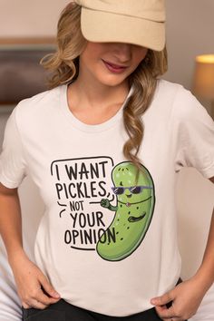 This Pickle Shirt is a must-have for anyone who prefers their snacks tangy and their statements bold. Show off your pickle-loving side with our "I want pickles not your opinion" shirt! The Pickle Shirt is printed with the bold "I want pickles not your opinion" in vibrant, eye-catching letters, making it clear where your preferences lie. The Funny Shirt is built to withstand countless washes without losing shape or color. It is designed with comfort in mind, featuring soft, blended fabric. This P Novelty Cotton Tops With Funny Text, Novelty Tops With Funny Print And Relaxed Fit, Novelty Cotton Tops With Text Print, Cotton Novelty Top With Text Print, Novelty Cotton Tops With Screen Print, Novelty Cotton Shirt With Slogan, Novelty Screen Print Tops For Summer, Novelty Screen Print Summer Tops, Relaxed Fit Tops With Funny Print