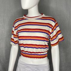 This groovy short sleeve features rainbow stripes top to bottom, and a cinched hem around the waist. 70% Cotton 20% Polyester 10% Rayon Model is wearing a size S Rainbow Striped Top, Stripes Top, Hippie Van, Happy Hippie, Striped T Shirt, Rainbow Stripes, Stripes, Rainbow, Christmas