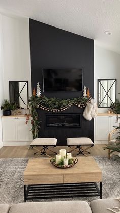 the living room is decorated for christmas with candles and stockings on the fireplace mantel