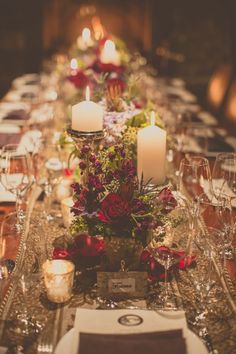 a long table is set with candles and flowers for an elegant dinner or party event