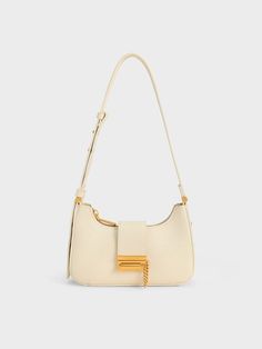 In a creamy chalk colourway, our metallic accent belted bag will slot seamlessly into your style rotation. Featuring a slouchy yet structured hobo silhouette and gold-tone metallic hardware, this bag will add a touch of sophistication to your ensembles. The adjustable belt strap not only lets you customise the length perfectly, but also injects a streetwise edge to this chic carryall. Golden Bday, Charles And Keith Bags, Charles And Keith, 2023 Wishlist, Eyewear Chain, Expensive Bag, White Accessories, Charles Keith, Adjustable Belt