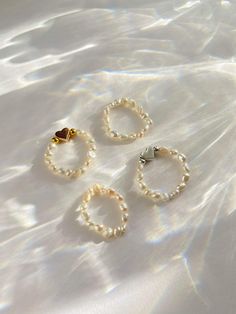 Our Callie rings are absolutely stunning!  Choose from either a silver or gold mini pearl heart ring and a plain mini pearl ring- or both! They create a beautiful ring stack.  These rings are made with elastic cord which makes them stretchy/adjustable by a few ring sizes. Ideas Pulseras, Message Necklace, Pearl Rings, Freshwater Pearl Ring, Pearl Heart, Ring Stack, Diy Rings, Sea Glass Necklace, Ring Sizes