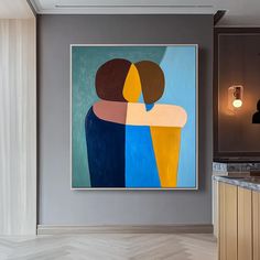 an abstract painting hangs on the wall above a kitchen island