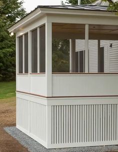 a white gazebo sitting on top of a gravel field