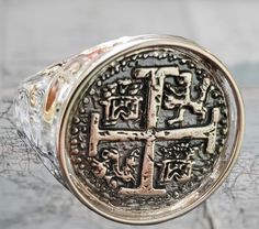 This ring is absolutely stunning in person. The band has a hammered finish and is solid sterling silver.  The coin itself is casted from the silver bars recovered from the Atocha and comes with a certificate stating that. This ring has a very rich and polished look in person. Gold Coin-shaped Engraved Ring, Shark Pendant, Key West Fl, Gold Overlay, Silver Bars, Men's Ring, Coin Pendant, Silver Coins, Mini Me