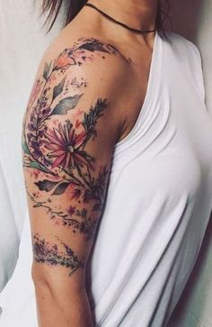 a woman with a flower tattoo on her arm