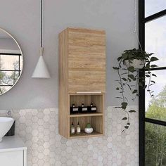 a bathroom with a sink, mirror and cabinet in it's corner next to a window