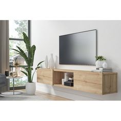 a flat screen tv mounted to the side of a wooden shelf in a living room