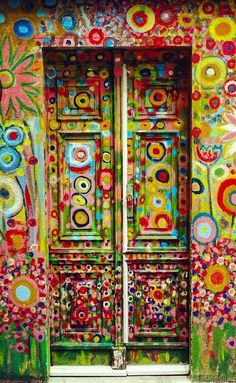 an open door is painted in bright colors