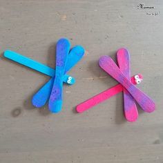 two popsicle sticks are made to look like dragonflies