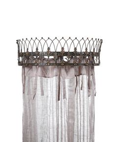 a curtain with metal rods hanging from it's side and an iron rod at the top