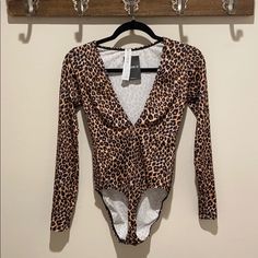 Sexy Long Sleeve Low Cut Animal Print Bodysuit. Great For A Night Out On The Town, A Halloween Costume Party Or Just For Fun. Final Sale Due To Hygiene. Please Ask Questions Before Purchasing. Item Comes From A Smoke Free Super Clean Home. *Please See All Pics And Note The Size On Item Is Large However The Store Accidentally Tagged This Item Xl. Stretch Leopard Print Bodysuit For Night Out, Halloween Stretch Bodysuit For Night Out, Fitted Leopard Print Bodysuit For Party, Trendy Brown Bodysuit For Night Out, Flirty Fitted One-piece Bodysuit, Brown Stretch Bodysuit For Night Out, Brown Bodysuit For Night Out In Fall, Brown Fall Bodysuit For Night Out, Fitted Leopard Print Swimwear For Party