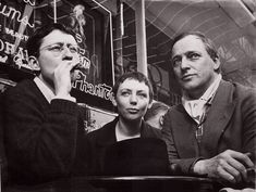 black and white photograph of three people sitting at a table