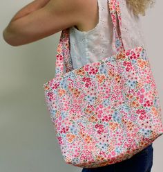 Classic quilted cotton tote bag in a colorful floral print. Handmade in our North Atlanta atelier. Dimensions: 15" x  11.5" x 4" Strap Handle: 12.5" Composition: 100% Cotton 2 inside pockets Eco-friendly Everyday Bags With Floral Print, Everyday Cotton Shoulder Bag With Floral Print, Multicolor Floral Print Canvas Bag For Everyday, Floral Print Cotton Shoulder Bag, Everyday Cotton Canvas Bag With Floral Print, Multicolor Floral Print Tote Canvas Bag, Multicolor Floral Print Canvas Tote Bag, Daily Use Cotton Bag With Floral Print, Everyday Floral Print Cotton Canvas Bag